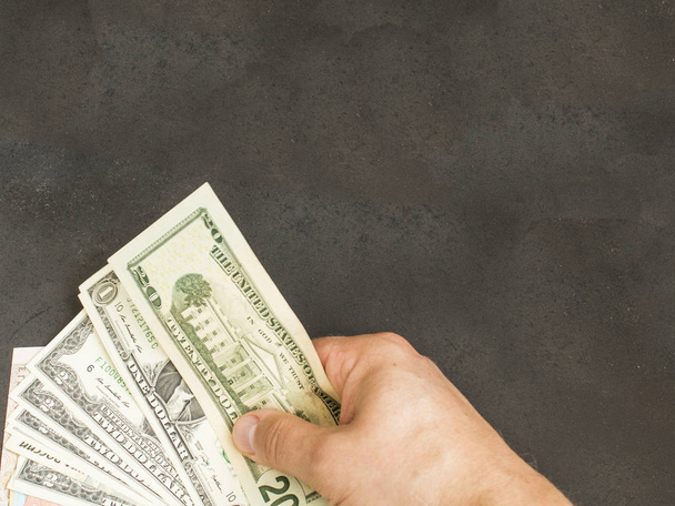 hand with money on a dark background - Foto, Imagem