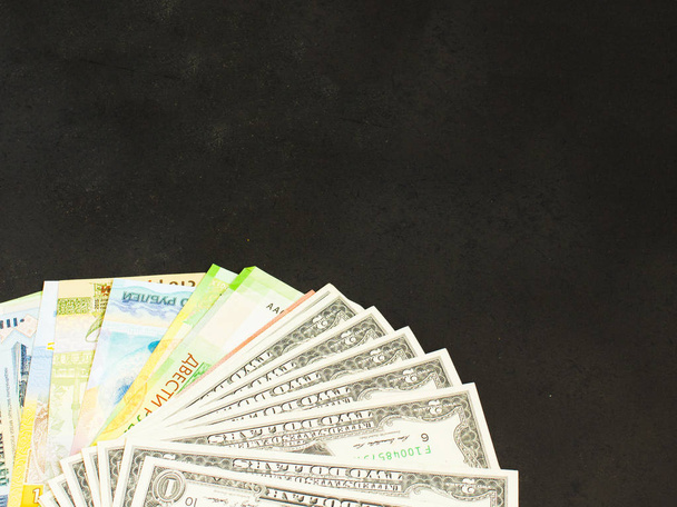 a lot of money lying on the black table - Фото, зображення