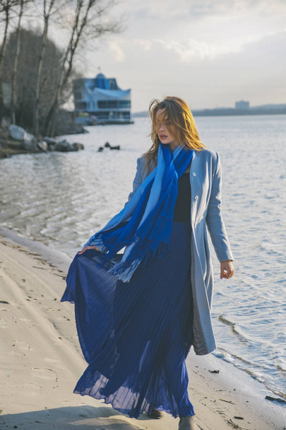Gorgeous european woman in warm coat and dress on a walk in park - Zdjęcie, obraz