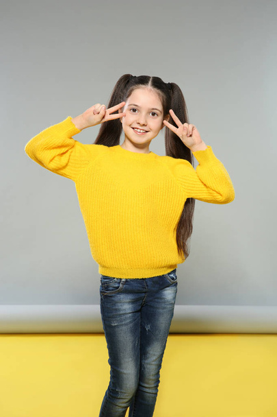 Portrait of little girl posing on grey background - Photo, image