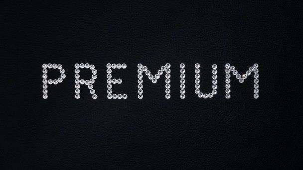 Slovo Premium z lesklých bílých krystalů swarovski umístěných na černé kůži - Fotografie, Obrázek