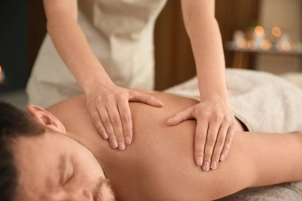 Handsome man receiving back massage in spa salon, closeup - Fotoğraf, Görsel