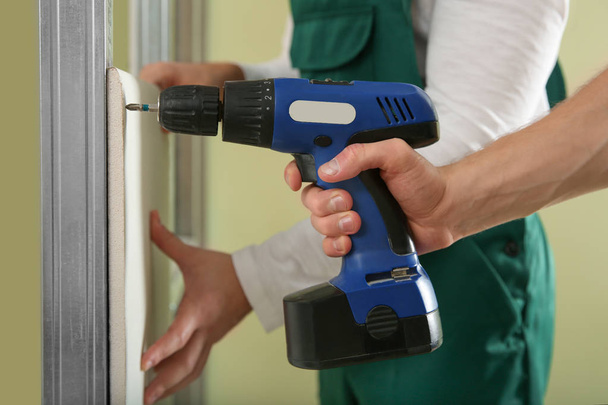 Workers installing drywall indoors, closeup. Home repair service - 写真・画像