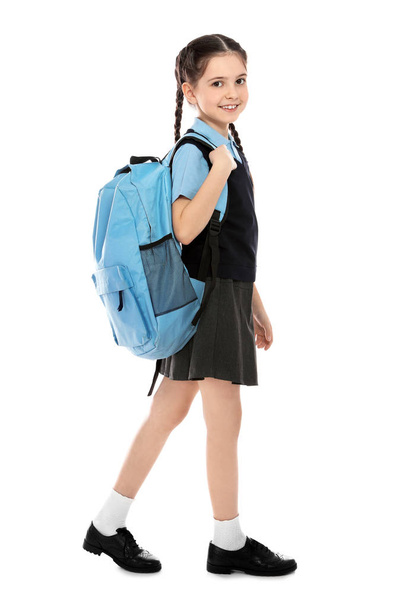 Full length portrait of cute girl in school uniform with backpack on white background - Valokuva, kuva