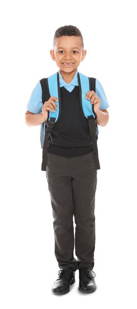 Full length portrait of cute African-American boy in school uniform with backpack on white background - Foto, immagini