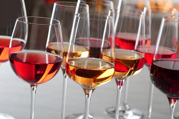 Glasses with different wines on blurred background, closeup - Фото, зображення