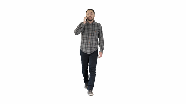 Young man talking on mobilephone on white background. - Footage, Video