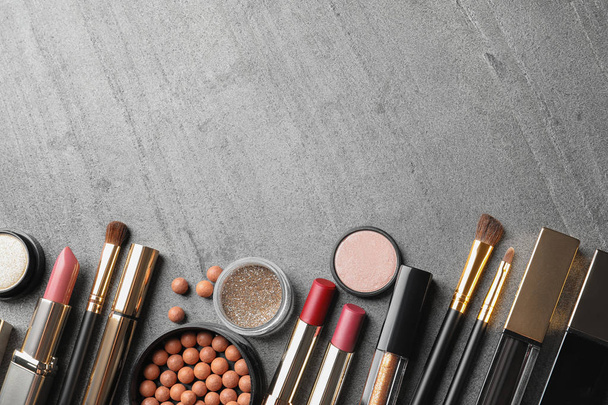 Set of luxury makeup products and space for text on grey background, flat lay - Foto, immagini