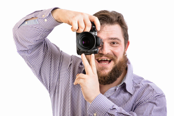 portrait of big handsome bearded photographer taking photo with professional DSLR camera, isolated on white - Фото, изображение