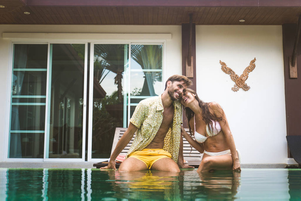 Couple of lovers in a beautiful villa with swimming pool - Φωτογραφία, εικόνα