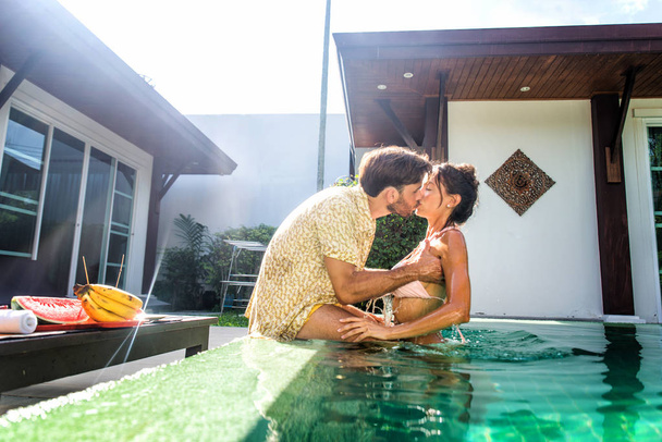 Couple of lovers in a beautiful villa with swimming pool - Photo, image
