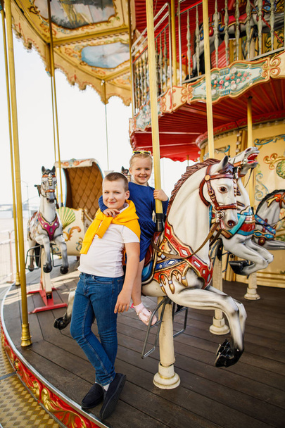 little children brother and sister having fun on the carousel - Fotoğraf, Görsel