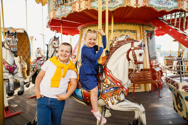 little children brother and sister having fun on the carousel - Zdjęcie, obraz