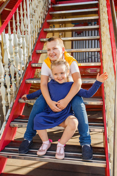 little children brother and sister having fun on the carousel - Valokuva, kuva