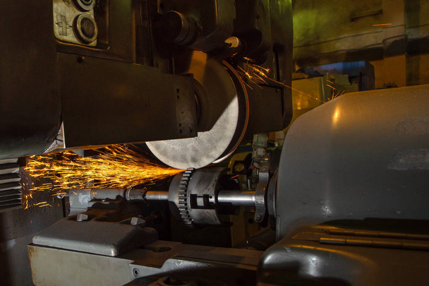 Grinding machine, grinding with sparks a gear wheel in the automotive industry - Photo, Image