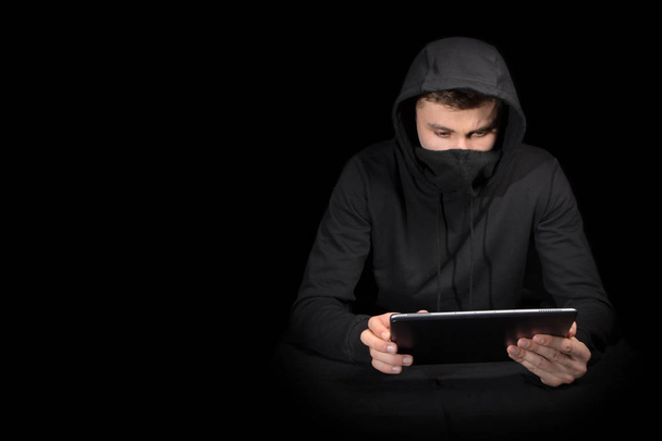 Hacker with tablet PC initiating cyber attack, isolated on black - Foto, Imagen