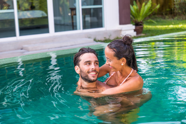 Couple of lovers in a beautiful villa with swimming pool - Photo, Image
