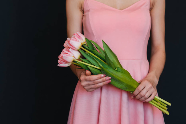 bouquet of pink tulips in women's hands - Photo, image