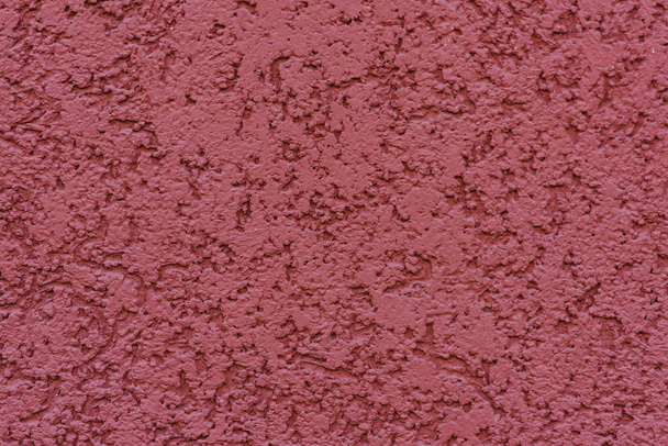 structuur van getextureerde pleister op rode muur - Foto, afbeelding