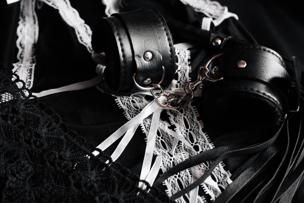 sexual toys for submission and domination in BDSM sex. Whip and handcuffs - Φωτογραφία, εικόνα