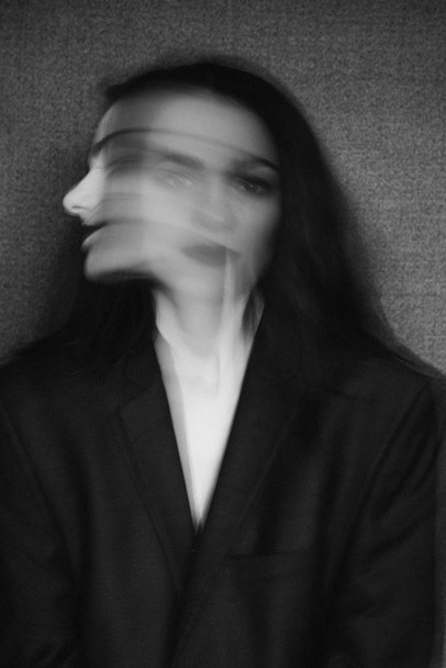 crazy portrait of girl with mental disorders and split personality. Black and white with added grain and motion blur - Photo, Image