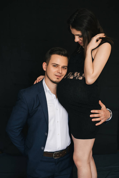 pregnant couple hugging. Lovers fashionable young man and woman - Photo, Image
