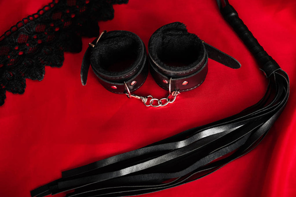 Menottes en cuir et fouet BDSM pour les jeux sexuels de rôle
 - Photo, image