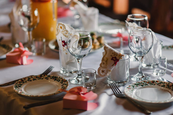 set of empty glasses and plates with Cutlery on a white tablecloth on the table in the restaurant - Photo, Image