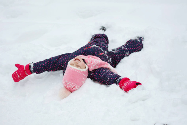 Νεαρό κορίτσι που εκπροσωπεί ένα χιόνι Άγγελος. - Φωτογραφία, εικόνα