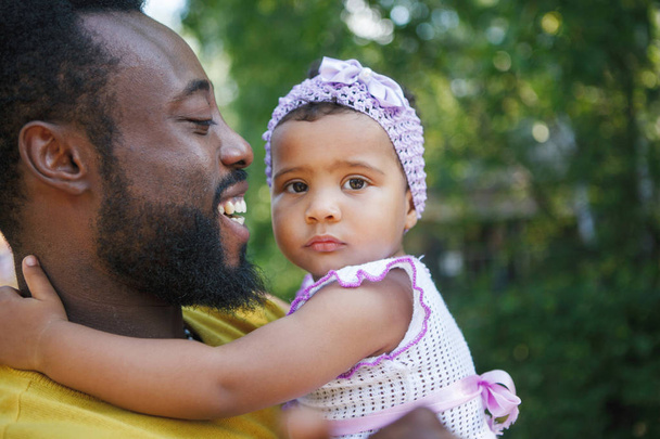African father holds his little daughter in his arms, hugs and k - Photo, image