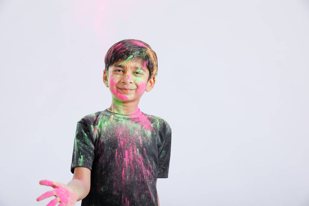 Indian little boy playing with the color and giving multiple expressions in holi festival  - Foto, immagini