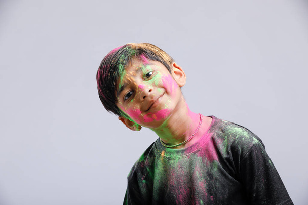 Indian little boy playing with the color and giving multiple expressions in holi festival  - Φωτογραφία, εικόνα