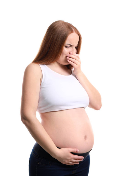Young pregnant woman suffering from toxicosis on white background - Фото, изображение