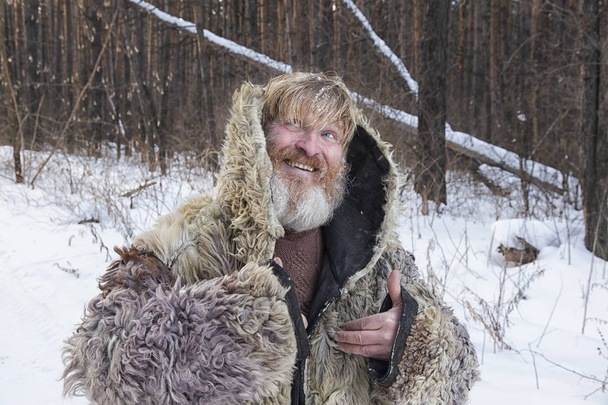 Bearded cheerful man in the winter forest. - Valokuva, kuva