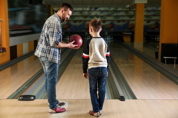 Man with his little son in bowling club - Zdjęcie, obraz