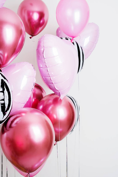 Set of pink and striped balloons in form of heart and round pink and striped on pastel pink background - Foto, imagen