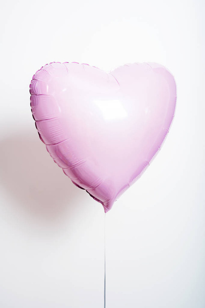 Pastel pink balloon in form of heart on white background - Fotoğraf, Görsel