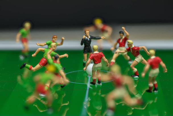Side view of miniature toys figurines football (soccer) players  - Photo, Image