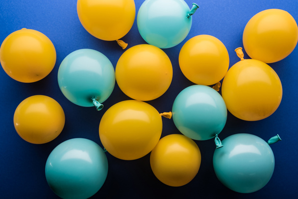 Top view of yellow and blue balloons festive background - Photo, Image