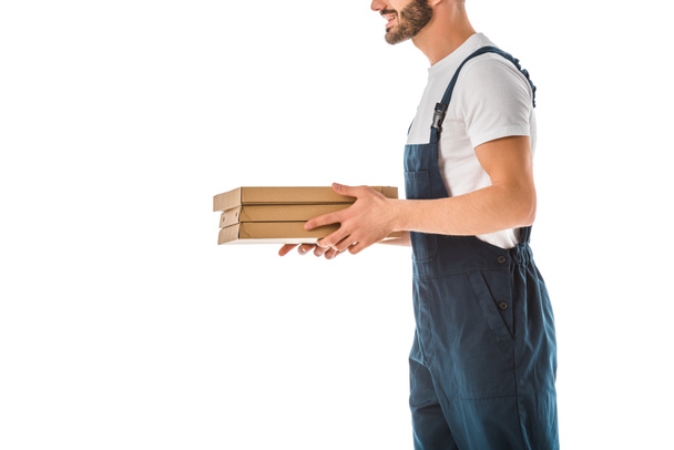cropped view of delivery man holding pizza boxes isolated on white - Fotó, kép