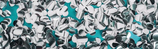 Panoramic shot of silver confetti on tiffany background  - Foto, afbeelding