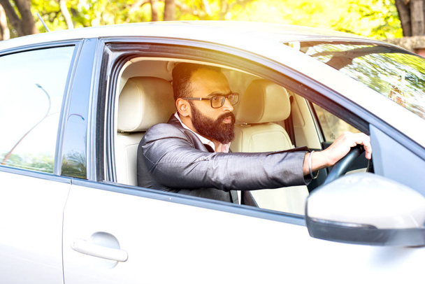 Indian Bearded businessman driving car, selective focus - 写真・画像