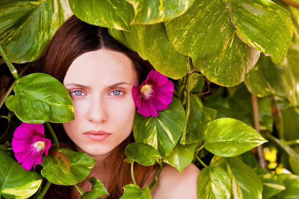 Wonderfull woman with flower in the leafs. - Photo, Image