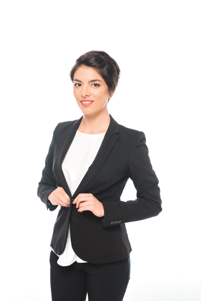 beautiful mixed race businesswoman in black formal wear smiling and looking at camera isolated on white - Φωτογραφία, εικόνα