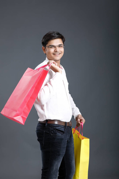 Young Indian man with shopping bags - Fotoğraf, Görsel