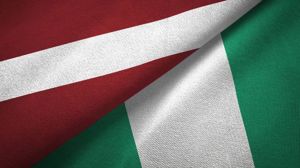 Lettland und Nigeria zwei Flaggen Textilstoff, Textur - Foto, Bild