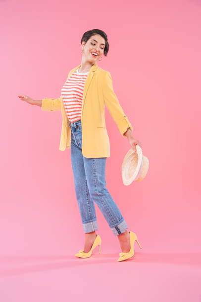 attractive mixed race woman in bright clothing posing at camera on pink background  - Fotografie, Obrázek