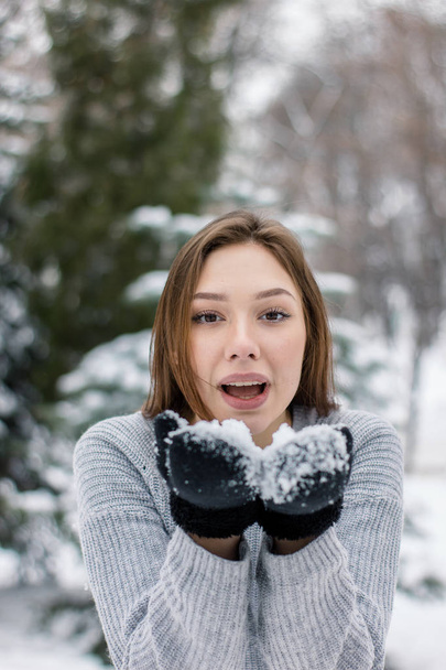 Милая молодая женщина наслаждается снежной погодой
 - Фото, изображение