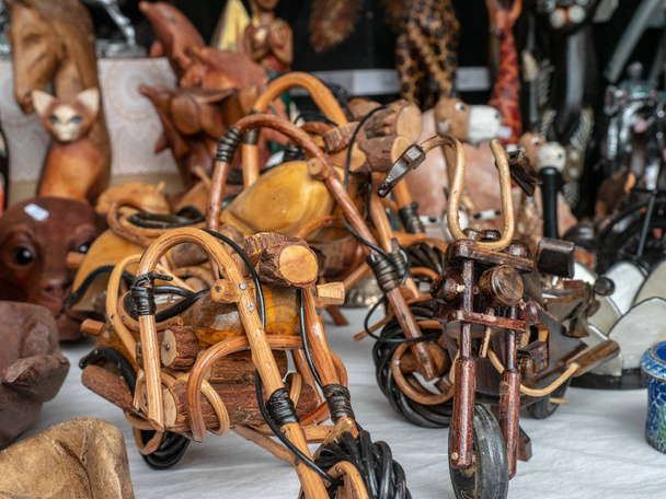 Miniatures of handmade wooden motorcycles at a flea market - Photo, Image