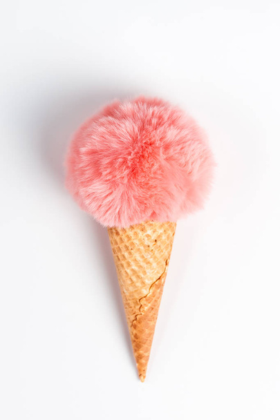 Coral fur ball in waffle cone on white background - Photo, Image